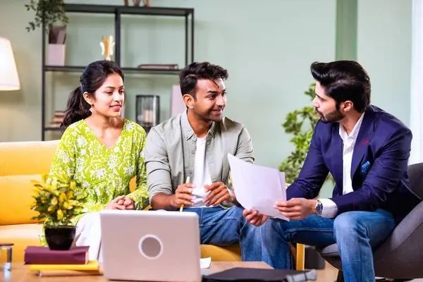 Couple consulting an advisor at home